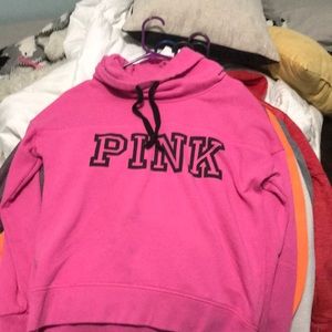 A pink turtle neck sweatshirt